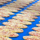 frozen pizza on an assembly line